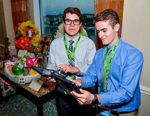Volunteers with iPads assist guests.