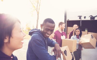 Volunteers carrying boxes for clothing drive
