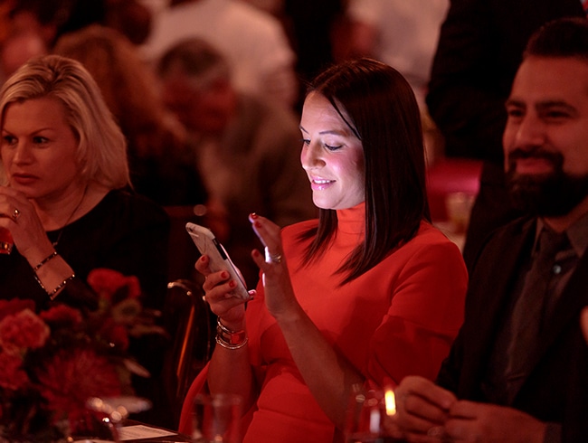Woman on a mobile phone using OneCause Mobile Bidding and Auction Software