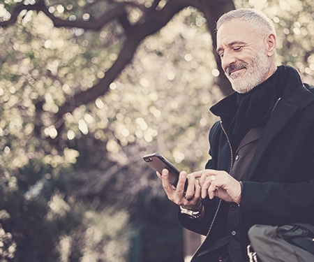 Man using a mobile device using online giving software to make a donation to a nonprofit organization