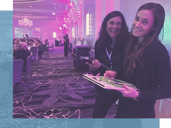 Two OneCause onsite event managers at a charity fundraiser