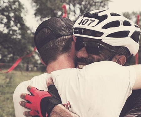 Biker hugging a coach during a peer-to-peer fundraising event.