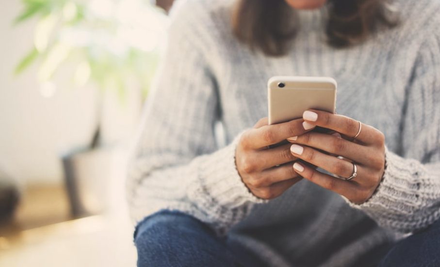 Woman on phone purchasing event tickets
