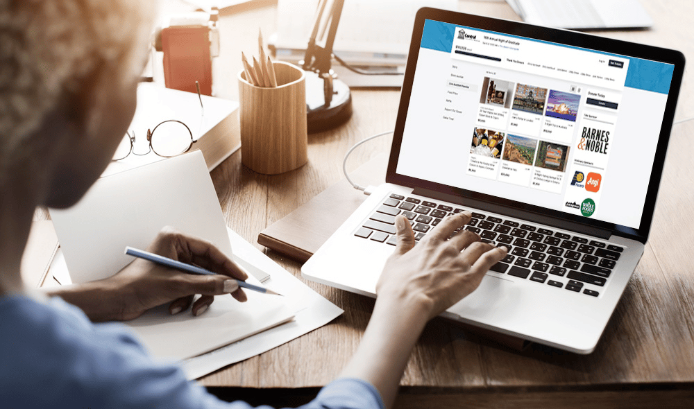 Woman on laptop using the OneCause Fundraising Platform