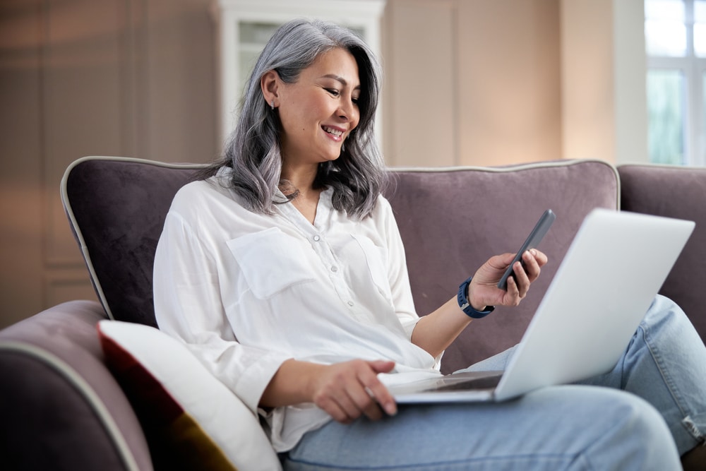 Woman on phone with laptop